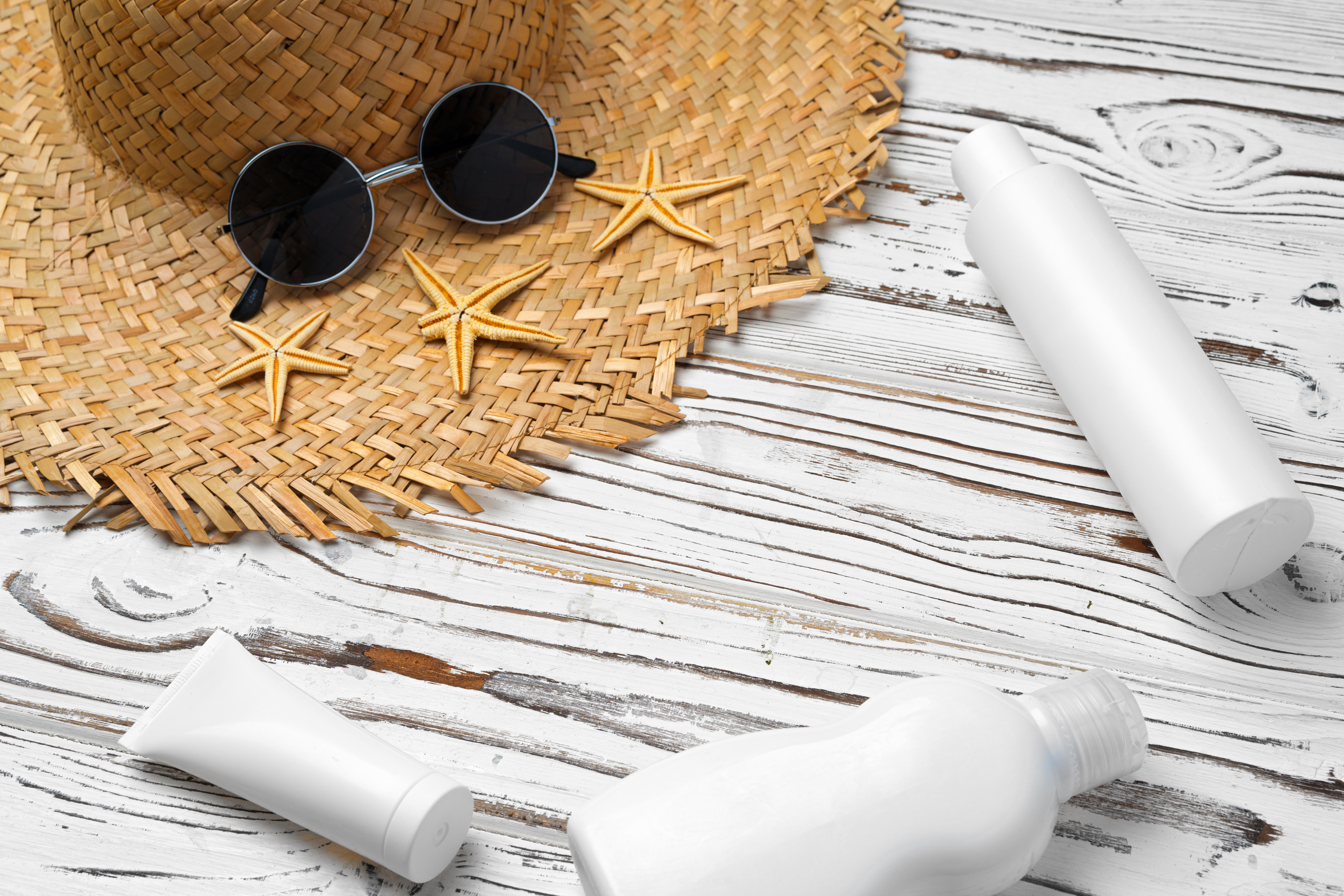 Straw Hat Sunglasses And Sunscreen Bottle On Wood 2023 11 27 05 27 55 Utc